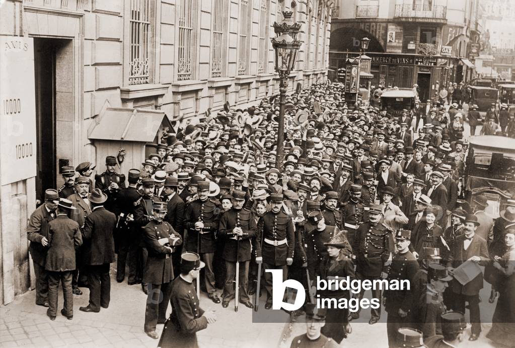 Paris police hold back a crowd making a run on a French bank. c. 1905-1915