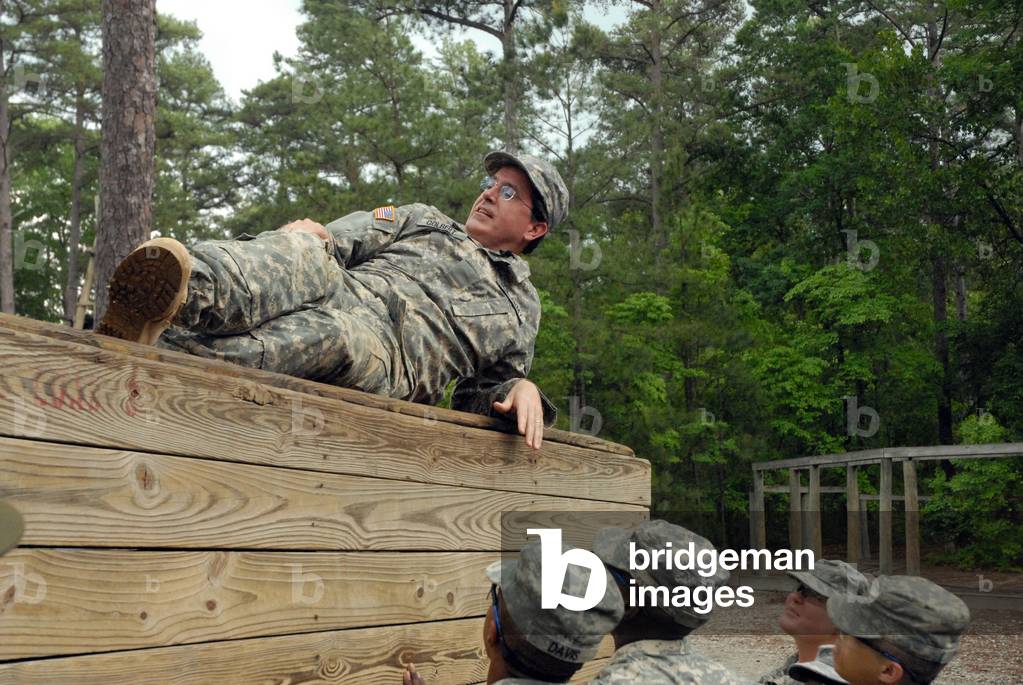 Political humorist Stephen Colbert tackles Basic Training. Army Private for a day Colbert rests atop an obstacle course wall rather than aiding his fellow Soldiers. June 2009