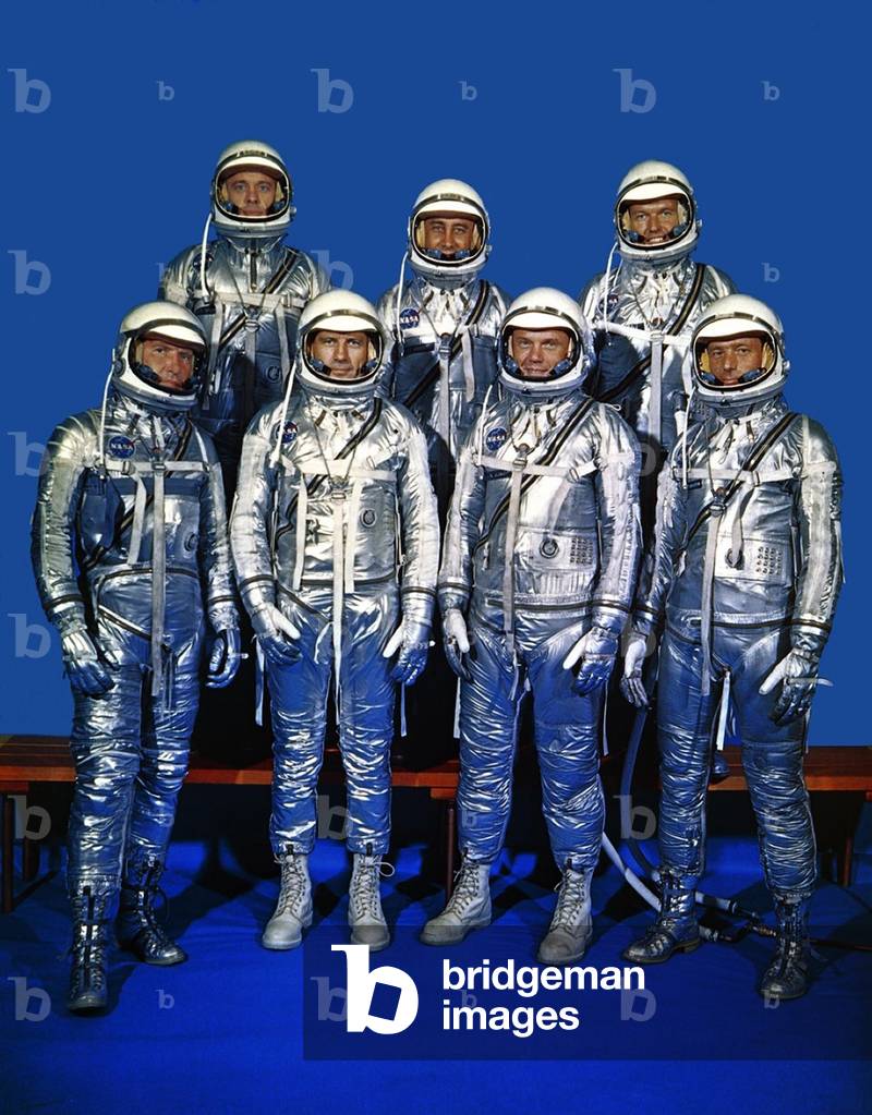 Project Mercury astronauts in their space suits. Front row, left to right, Walter H. Schirra Jr., Donald K. Slayton, John H. Glenn Jr., and Scott Carpenter; back row, Alan B. Shepard Jr., Gus Grissom, and L. Gordon Cooper. 1959