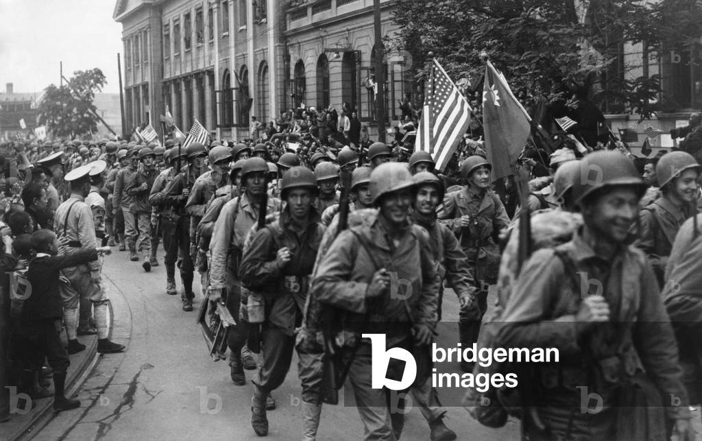 1st Div. U.S. Marines were greeted by crowds of Chinese in Tientsin, in Sept. 1945. When Japan surrendered in 1945, the 50,000 Marines of the now unnecessary invasion force were sent to China. Their mission was to accept surrender from Japanese and repatriate them. Also to help the Nationalists (as opposed to Communists) reassert their control over areas vacated by the Japanese