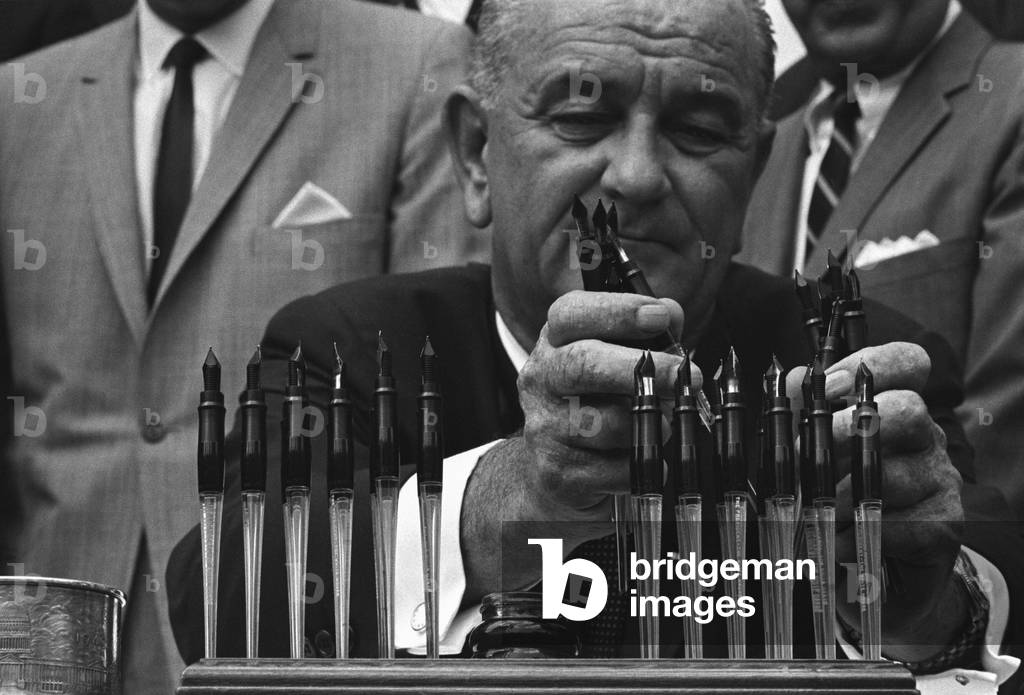 LBJ's Great Society programs. President Lyndon Johnson with the many pens he will use to sign the Housing and Urban Development Act of 1965