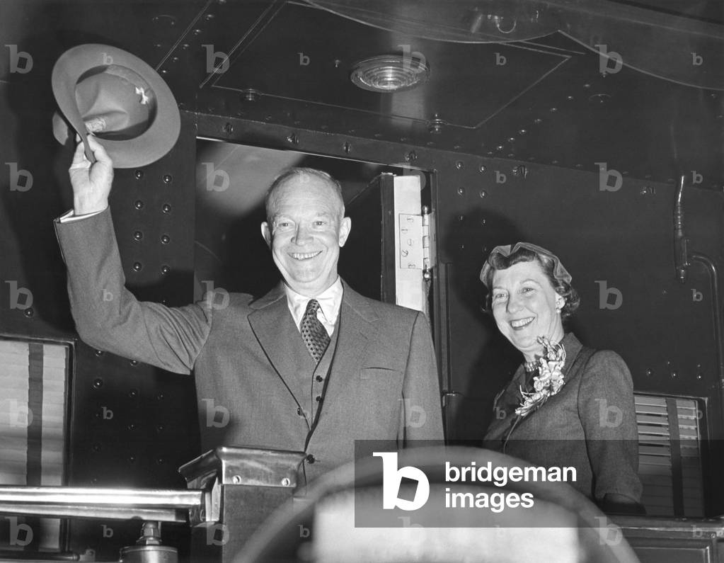President Eisenhower and wife Mamie wave from the back of a train. Nov. 14, 1953. They were departing for a three day trip to Canada.