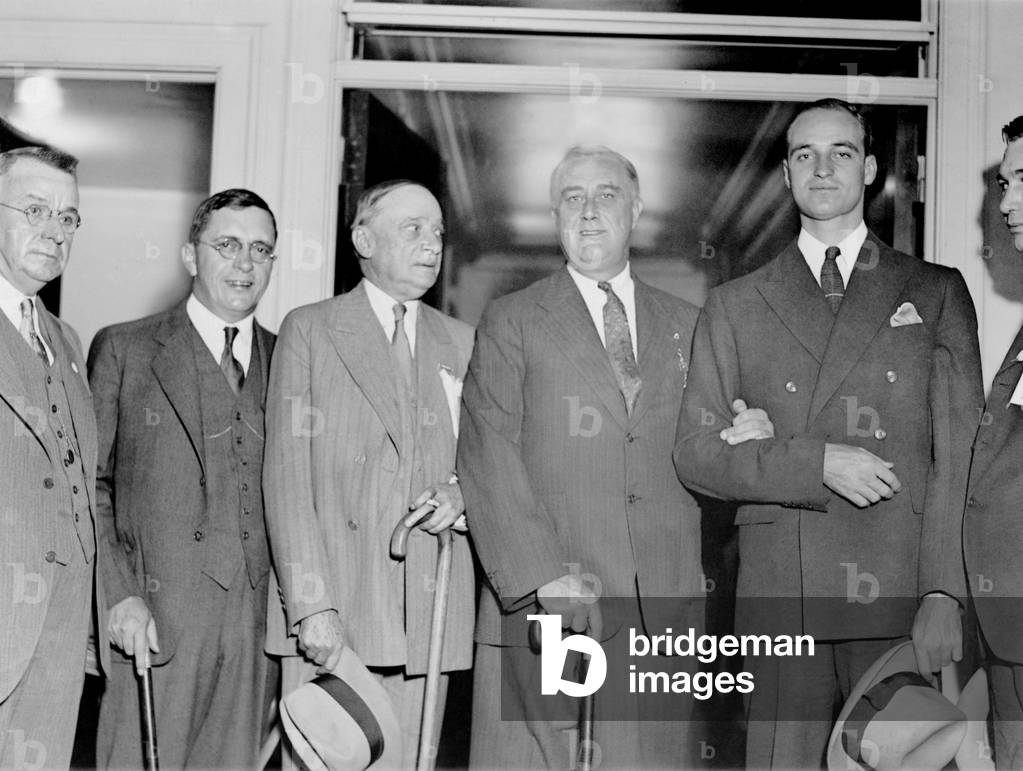 Franklin Roosevelt stands with politicians, and his son James in Atlanta. Oct. 24, 1932