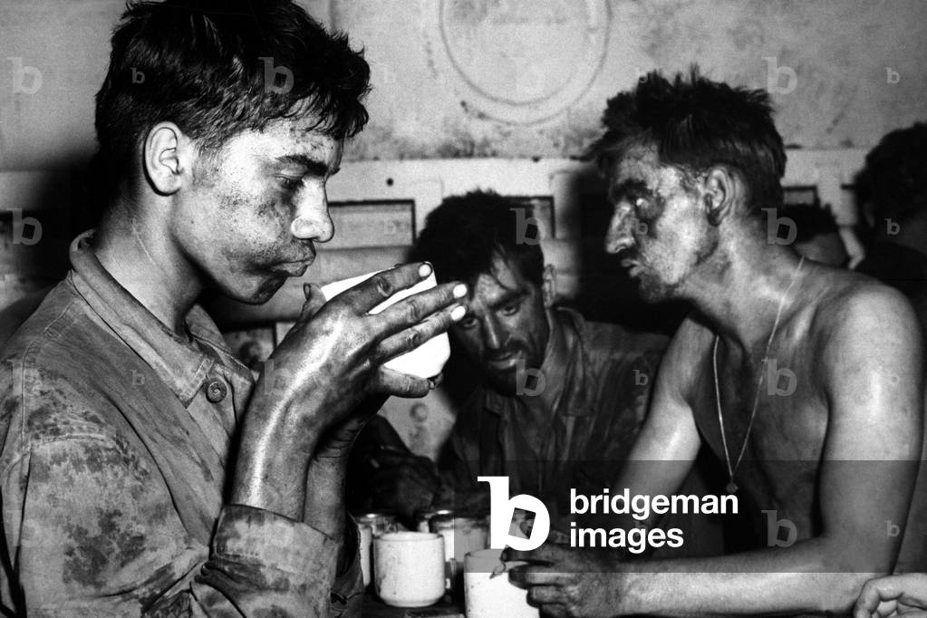 U.S. Marines after two days and nights of fighting on Eniwetok Island against Japanese. Marine holding the coffee cup is 19 year old Pfc. Faris Tuoly. Feb. 1944