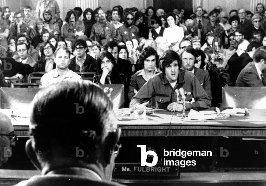 John Kerry giving testimony against the war to Senator J. William Fulbright (back to camera), 4/22/1971