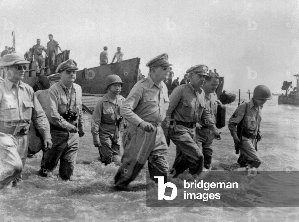 Gen. Douglas MacArthur wades ashore during initial landings at Leyte Island, Philippines. Oct. 20, 1944
