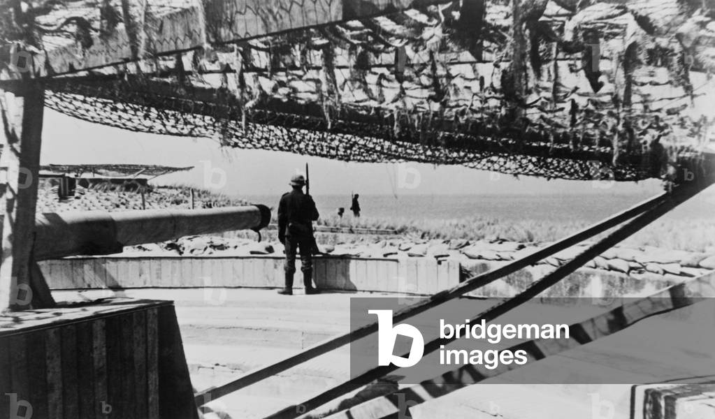 German soldiers guarding camouflage covered gun batteries on the Atlantic Wall. c. 1943-44. World War 2