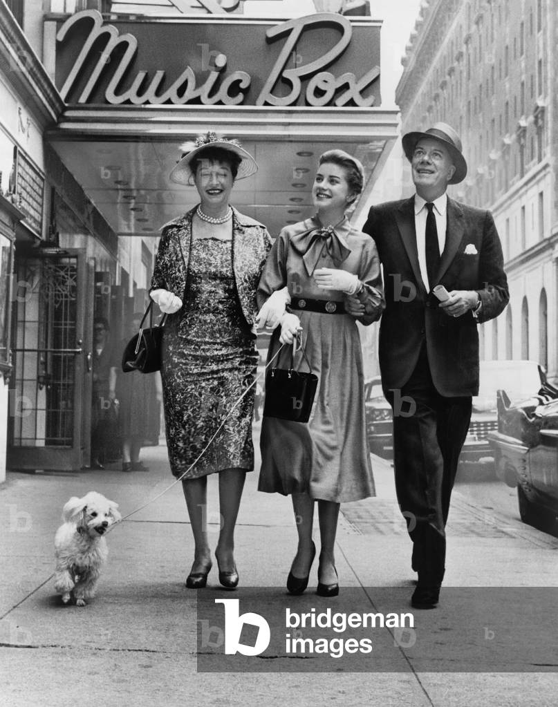 Cornelia Otis Skinner, Dolores Hart with dog on leash, and Cyril Ritchard, walking outside the Music Box theatre where they are starring in THE PLEASURE OF HIS COMPANY in 1959. The play was made into a movie starring Fred Astaire, Lilli Palmer, Debbie Reynolds, Tab Hunter, in 1961