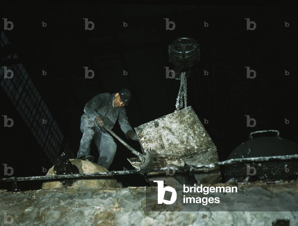 Worker spreading a hazardous asbestos mixture on boiler of a locomotive at a NYC railroad shops in December 1942. Asbestos' resistance to heat, electrical, and chemical damage made it a key industrial material before its serious health effects were known