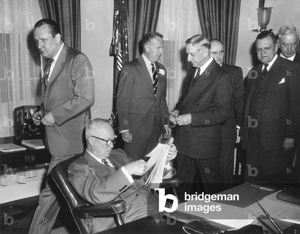 President Eisenhower reads the Highway Act of 1954 before signing. May 6, 1954
