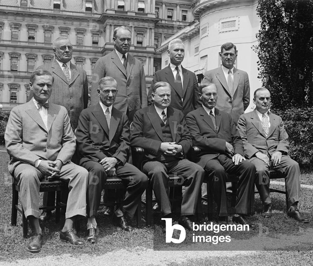 President Herbert Hoover (seated, center) with the Federal Farm Board, July 12, 1929. Created by the Agricultural Marketing Act of 1929, Federal Farm Board would loan money from its  million budget, to create and strengthen farm cooperatives to control production and reduce wasteful surpluses. Hoover preferred this voluntary cooperation rather than the government subsidies that many farmers preferred