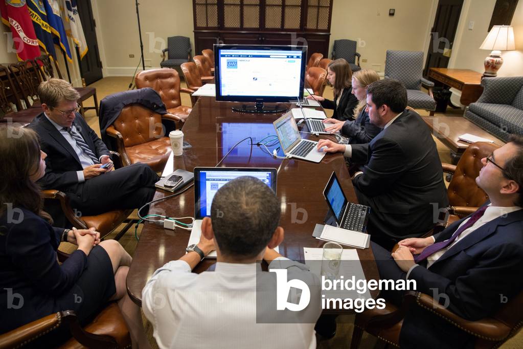 President Barack Obama (center, back to camera) in a live Twitter question and answer session. Roosevelt Room of the White House, Dec. 3, 2012