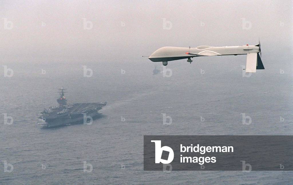 Predator Unmanned Aerial Vehicle flies above the aircraft carrier USS Carl Vinson on a Navy aerial reconnaissance test flight off the coast of California. Dec. 5 1995