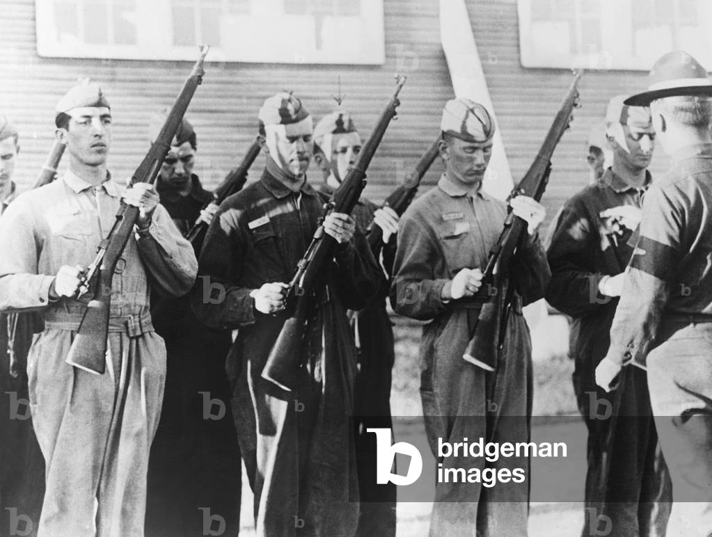 Alexis F. DuPont II in the (center with arrow) at inspection arms in the air corps' basic training. The heir to the DuPont millions enlisted as a regular rookie flyer. Brooks Field, Texas. Nov. 1927 -