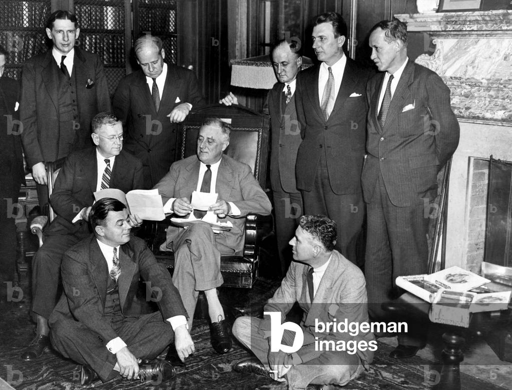 President Franklin D. Roosevelt, at work on the Works Relief Program. L-R, back: Charles West, Frank Walker, H. B. Hackett, Corrington Gill, Harry Hopkins, seated: Harold Ickes, President Roosevelt, front: Daniel Bell, Rexford Tugwell, September, 12, 1935