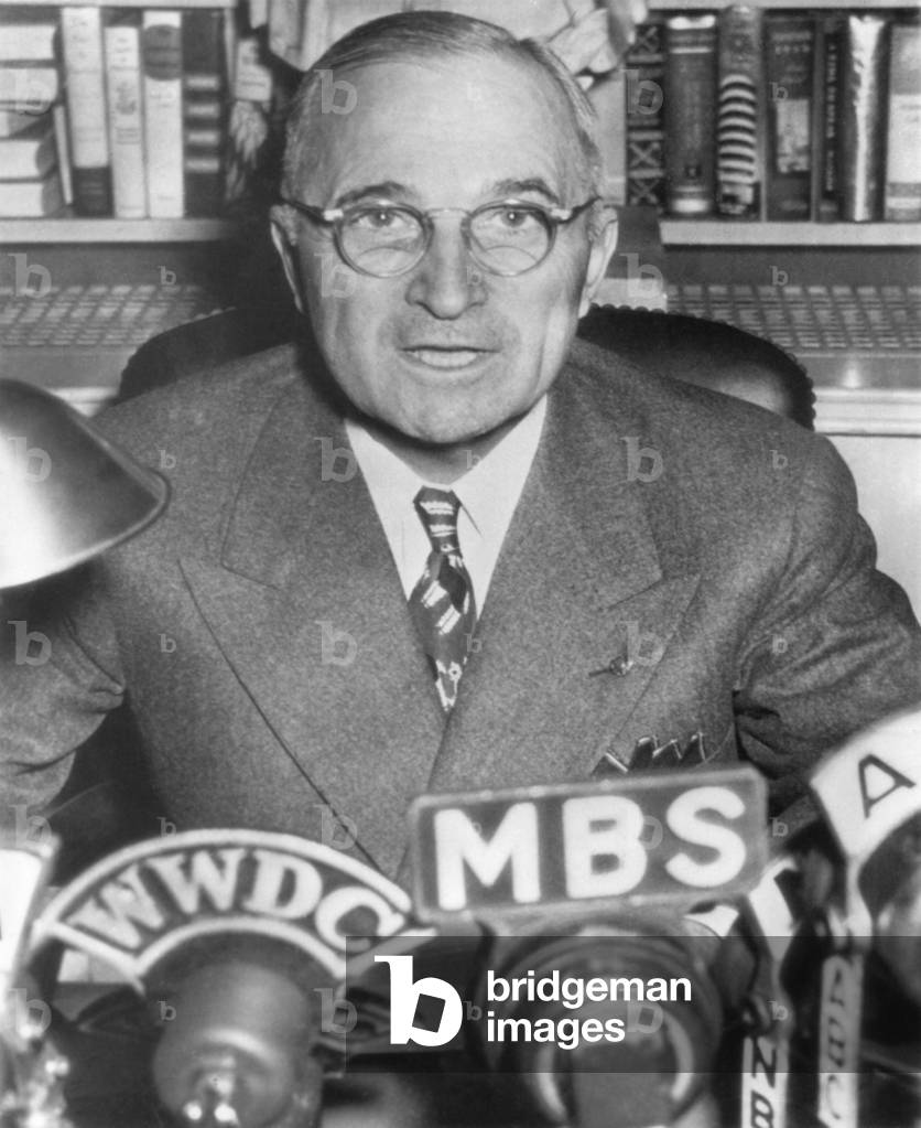 President Harry Truman speaking into microphones of radio networks. c. 1945-48.
