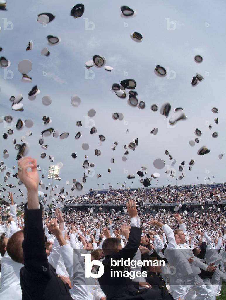 Newly commissioned officers toss their hats into the air at their 2006 graduation and commissioning ceremony. US Naval Academy in Annapolis Maryland. May 26 2006
