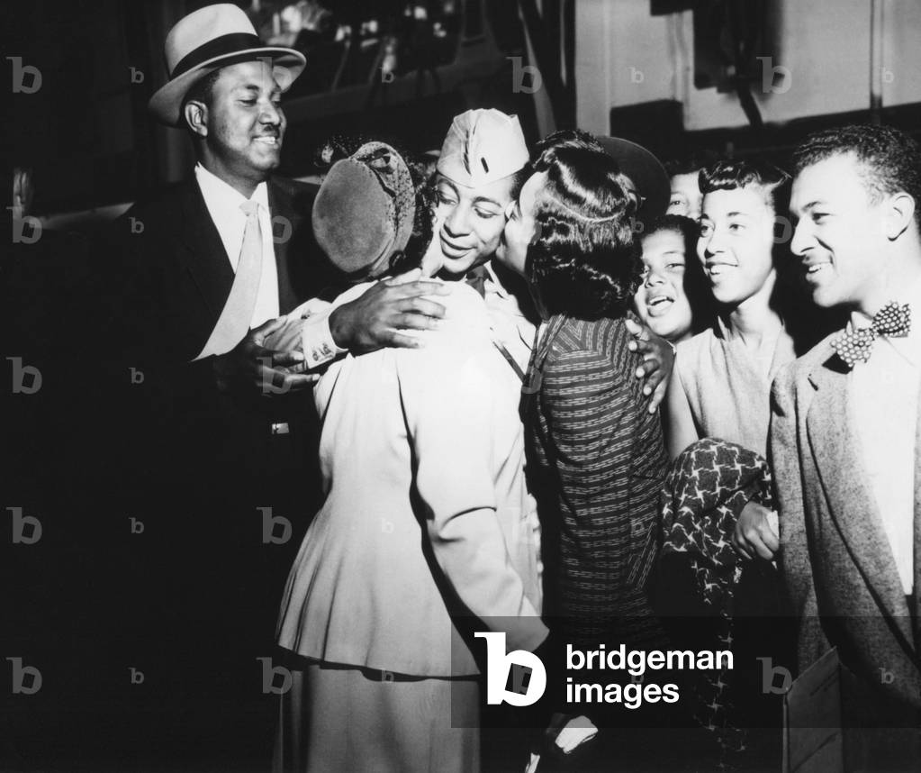 Army First Lt. Alvin Anderson embracing his mother and sister as his family looks on. He spent 33 months as a POW during the Korean War. Sept. 14, 1953. Fort Mason, California. Korean War, 1950-53