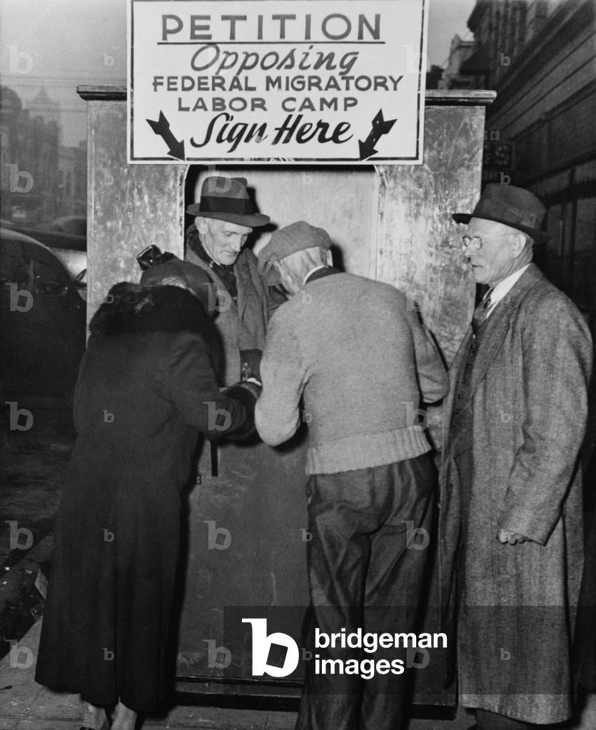 People sign a petition opposing establishment of government migratory labor camps in their community. The camps provided migrant workers with clean basic shelter. Portland, Oregon, 1939