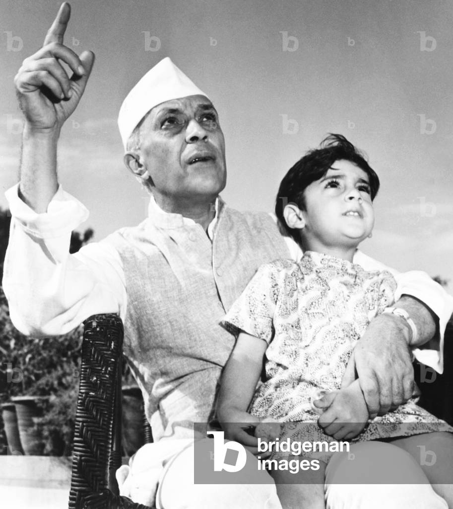 Jawaharlal Nehru, Premier of India, is shown talking with his 3-year-old grandson, Rajiva Gandhi. Rajiva became the 7th Prime Minister of India, from 1984 to 1989. He was assassinated while campaigning on May 21, 1991