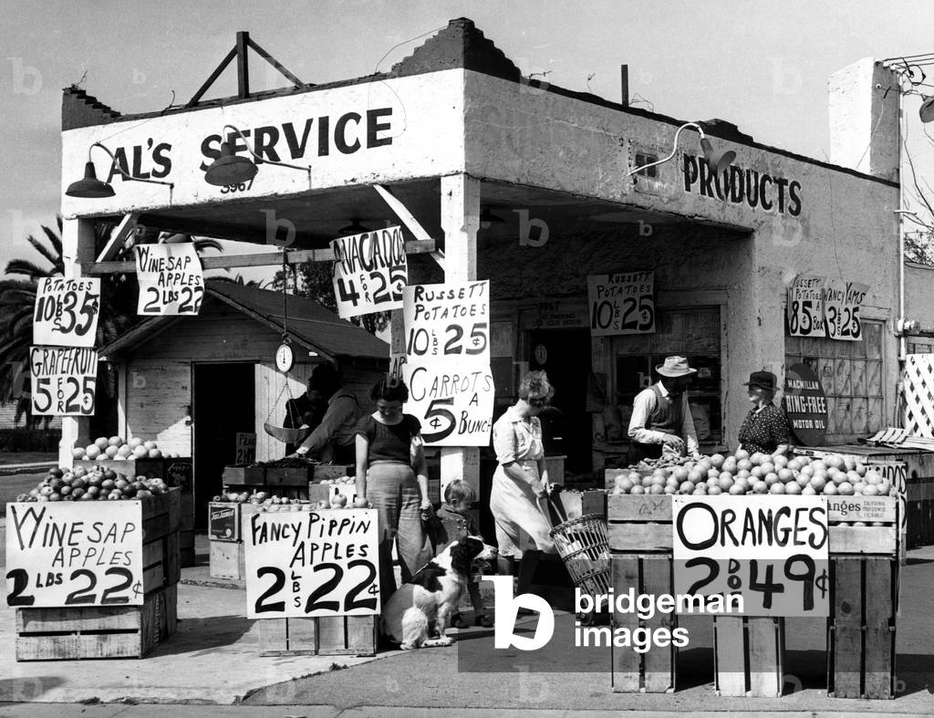 A Los Angeles gasoline station selling fruit and vegatables during a fuel shortage. Los Angeles, California, March, 1944