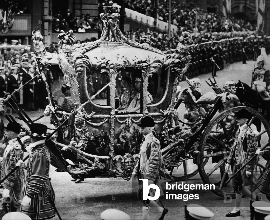 British Royalty. In coach: Queen Elizabeth (future Queen Mother) and King George VI of England, in coronation procession, Trafalgar Square, London, England, May 12, 1937