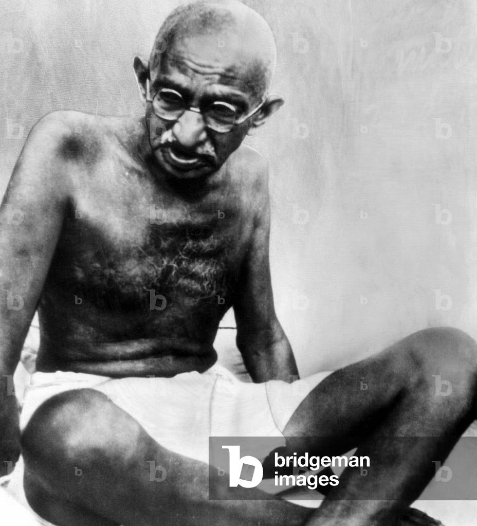 Mahatma Gandhi, 78, pauses during his walking tour. c. October 1947
