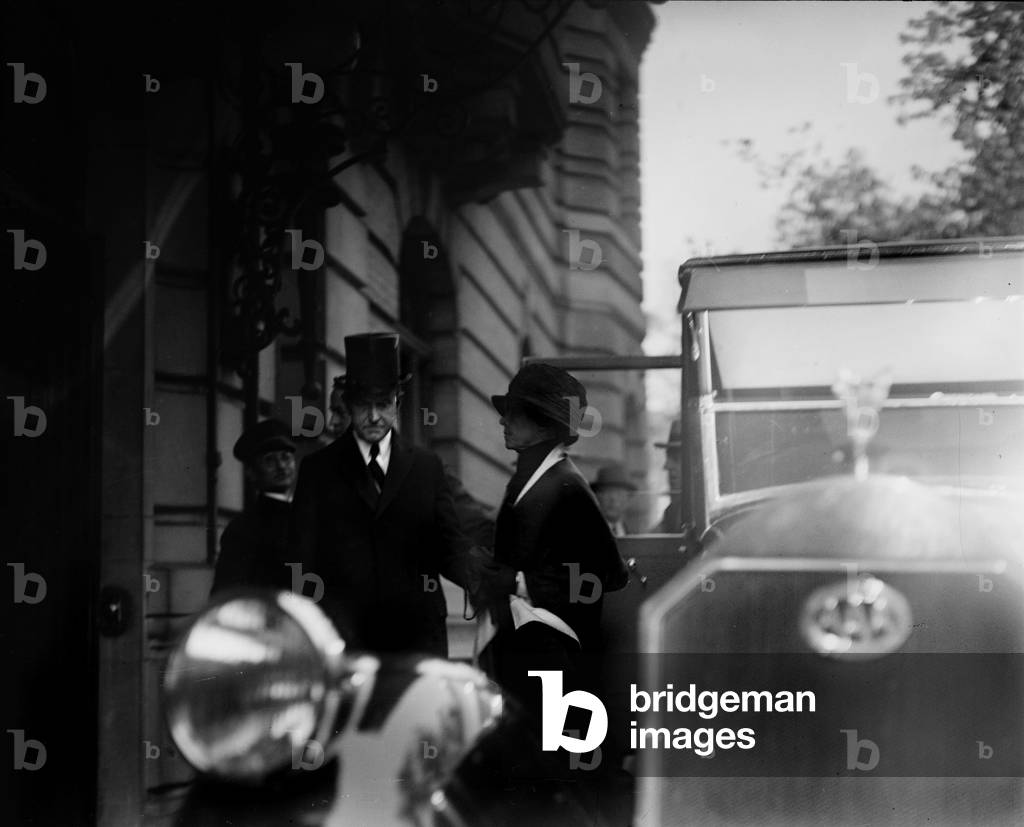 President Calvin Coolidge (front left), and First Lady Grace Coolidge (right), leaving home of Justice Joseph McKenna after a funeral, October 13, 1924