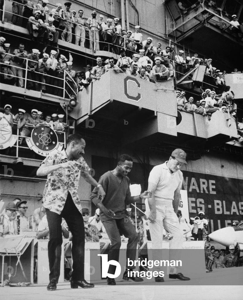 USO entertains troops in Vietnam. The Nicholas Brothers, Fayard and Harold, dance with Bob Hope on the USS Ticonderoga. Dec. 22, 1966