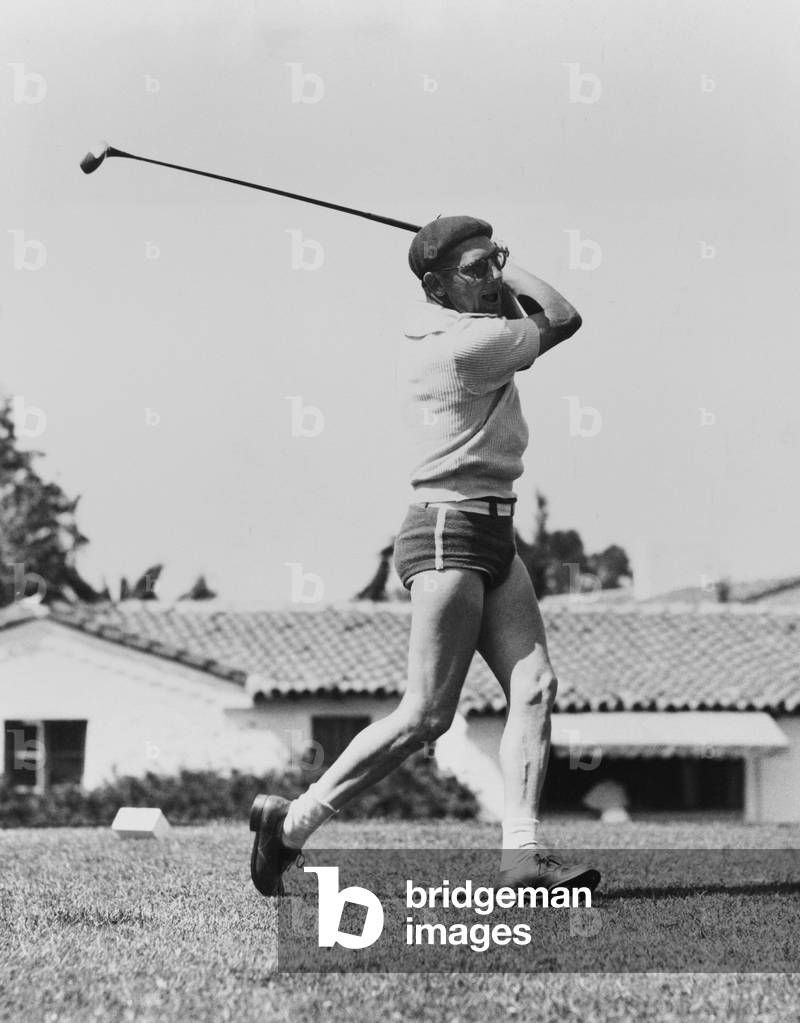 Chico Marx golfing at Avalon, Catalina Island, California. July 8, 1933. He is out of character, wearing his bathing suit and a beret