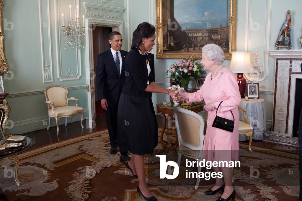 President and Michelle Obama meet with Queen Elizabeth II at Buckingham Palace in London England. Michelle wears an ivory and black silk crepe dress and jacket by Isabel Toledo. April 1 2009.,