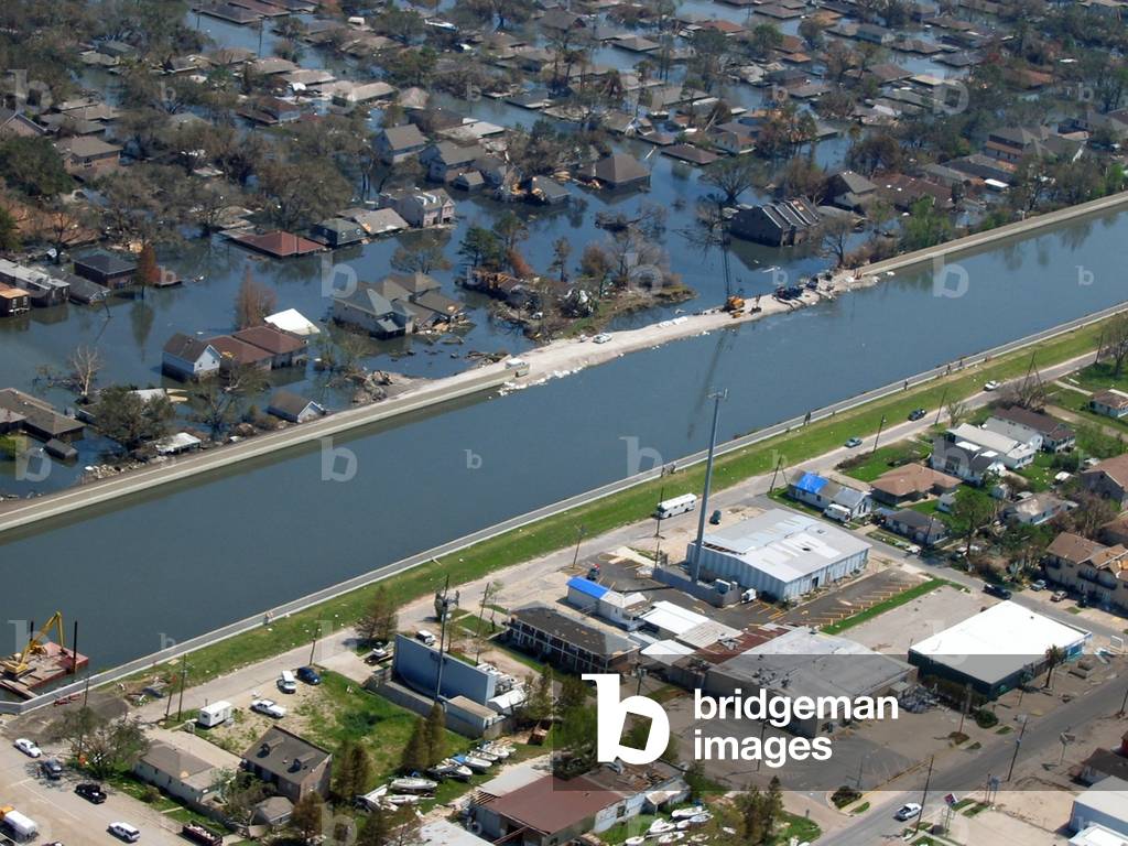 New Orleans after Hurricane Katrina showing a levee break under repair and flooding on one side with the other intact and dry. Sept. 2005