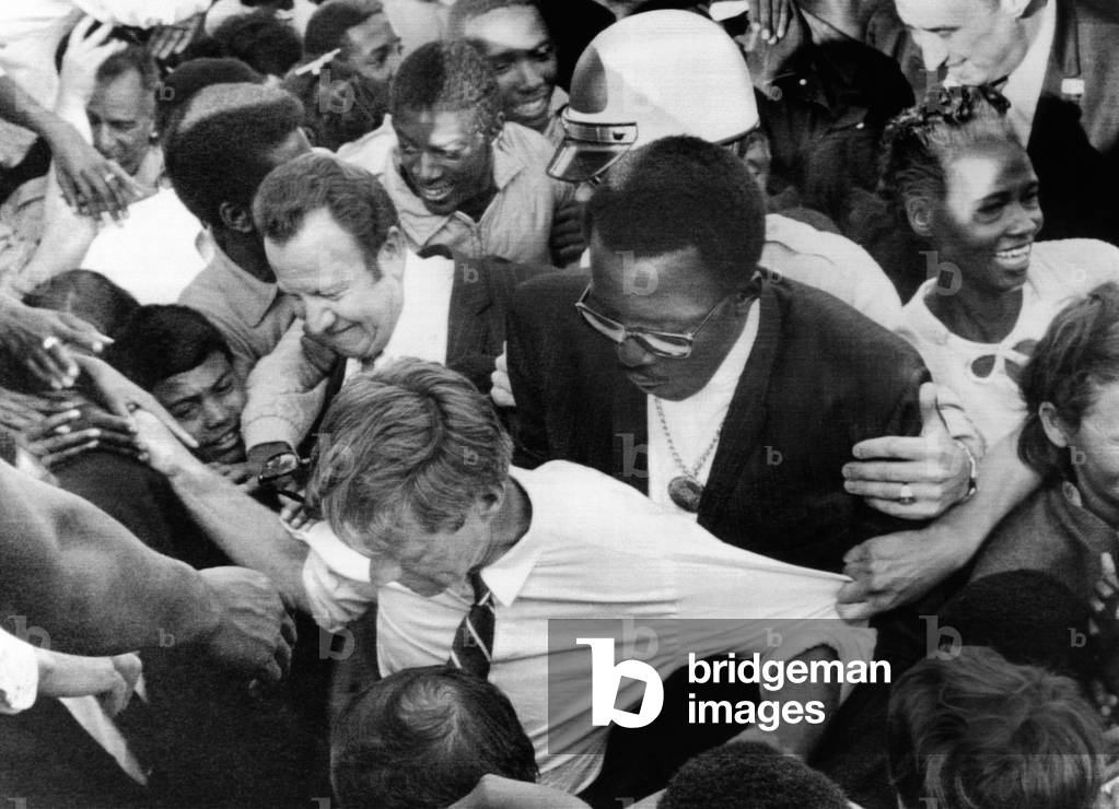 Sen. Robert Kennedy tugged at from every direction. The candidates fans overwhelm his security detail during his during his campaign in the California Democratic Presidential primary. Defermery Park, Oakland. May 31, 1968