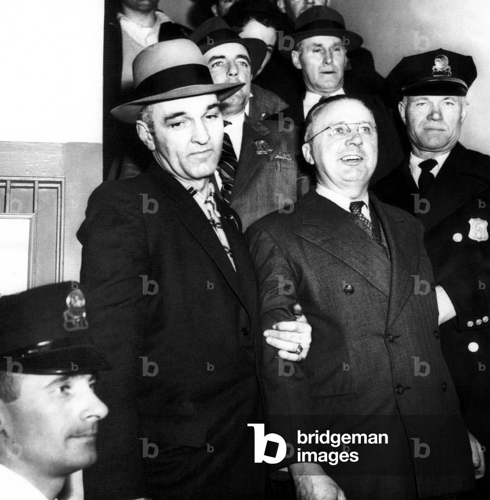 Foreground, center: George Metesky, (aka 'The Mad Bomber'), at his booking at Waterbury police station, Connecticut, January 22, 1957.