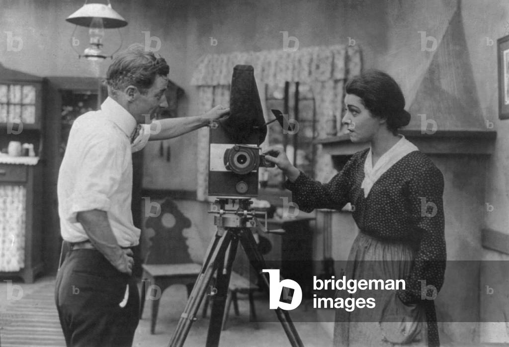 Alla Nazimova, (1879-1945), Ukrainian born American actress with director Herbert Brenon (1880-1958) talking near a movie camera. 1916