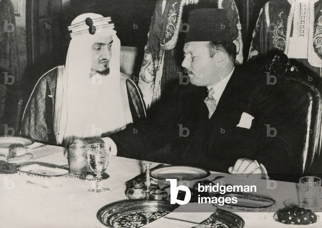 Prince Faisal l bin Abdulaziz of Saudi Arabia and King Farouk of Egypt. They dine at Ras el-Tin Palace in Alexandria following a meeting of the Arab League, April 9, 1946. Five of the nine resolutions passed in this Arab League session addressed actions t: Prince Faisal l bin Abdulaziz of Saudi Arabia and King Farouk of Egypt. They dine at Ras el-Tin Palace in Alexandria following a meeting of the Arab League, April 9, 1946. Five of the nine resolutions passed in this Arab League session addressed actions to resist Jewish settlement in Palestine. - (BSLOC_2014_15_211)