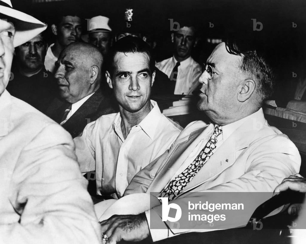 Governor Frank Merriam, Howard Hughes and Mayor Frank L. Shaw make their way through crowded streets during a reception in Los Angeles after Hughes' flight around the world, 1938