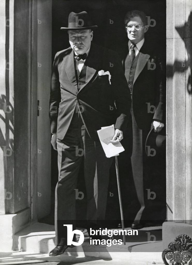 Prime Minister Winston Churchill leaving 10 Downing Street to speak to Parliament on June 18, 1940. He announced Britain has more than 1,250,000 men under arms and Britain would fight alone 'for years' if necessary. Behind him is Brendan Bracken, a Conservative Party Parliamentary Private Secretary to the Prime Minister. The Germans had just defeated France and British troops had retreated from Dunkirk to England.