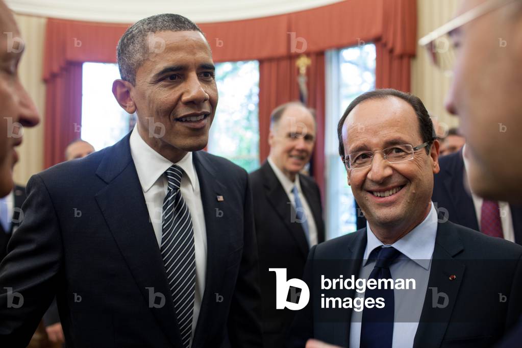 President Barack Obama and President François Hollande of France, with interpreters, hold a discussion following their bilateral meeting in the Oval Office, May 18, 2012.