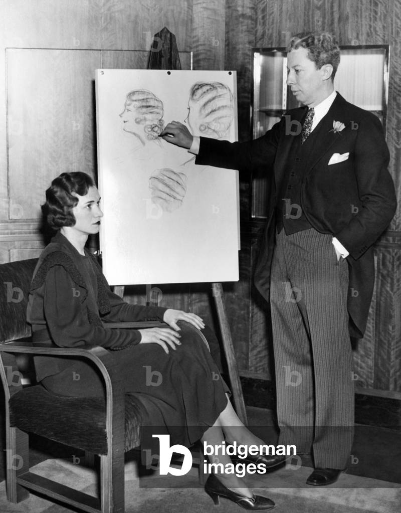 French coiffure stylist, Lucien, sketching waved hair styles. Dec. 6, 1937