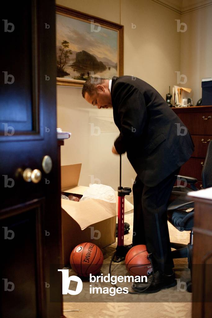 White House Butler Von Everett pumps up a basketball for President Barack Obama in the Outer Oval Office at the White House June 30 2009.,