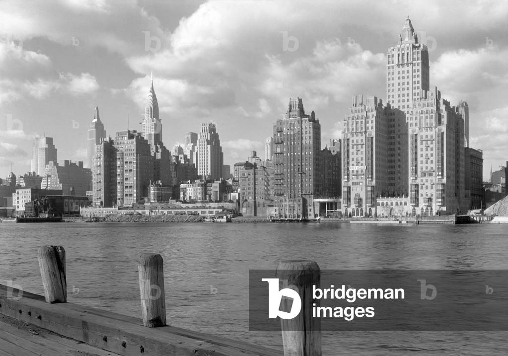 River House, was a new apartment building on 52nd St. and East River, New York City, Dec. 15, 1931. In the left foreground are port facilities. In distant left are the new Empire State and Chrysler Buildings. Photo by Samuel H. Gottscho