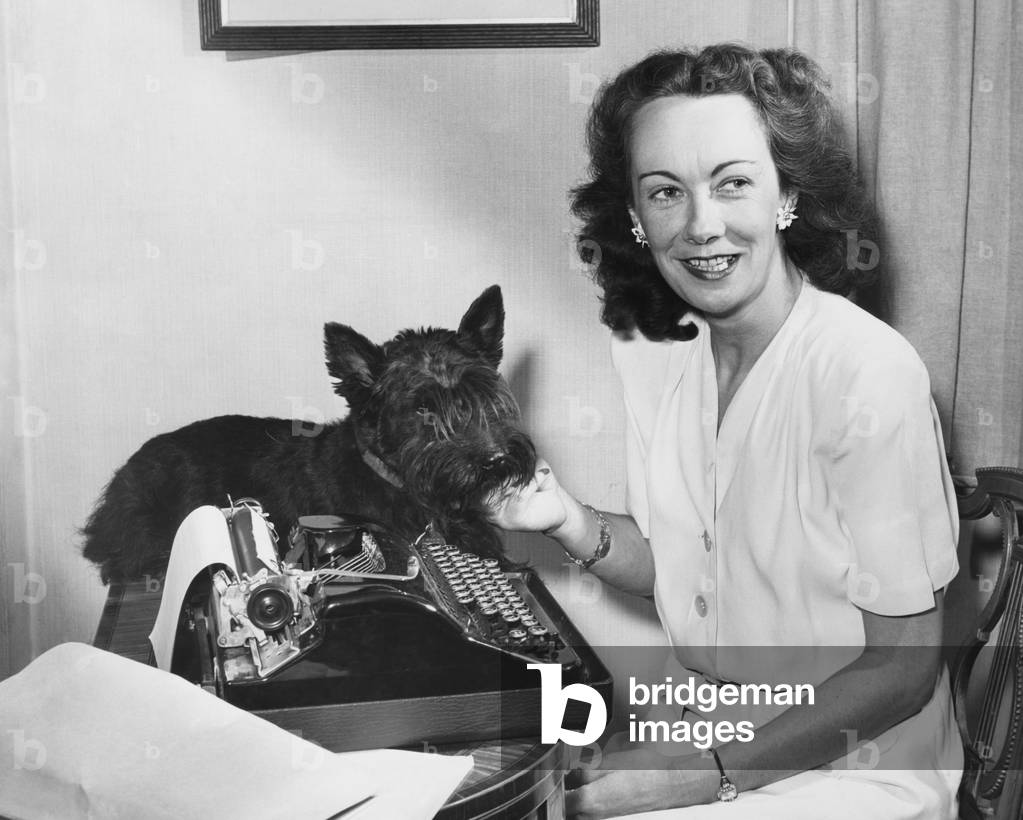 Kay Summersby at her typewriter with her pet scottie Telek, Publicity photo for her 1948 memoir, 'Eisenhower Was My Boss.'