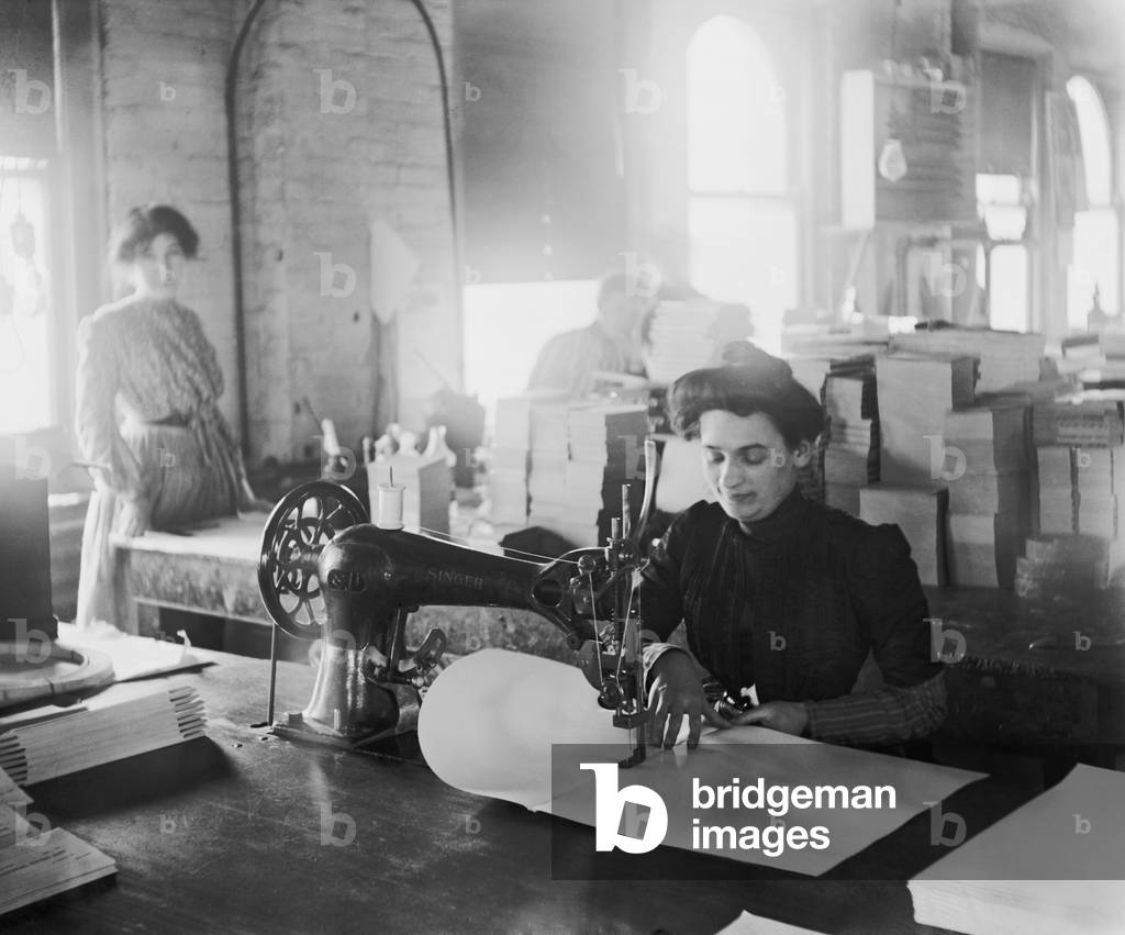 Middle-aged woman sewing on a belt driven Singer machine at the Richmond & Backus Company, Detroit, Michigan, c. 1905