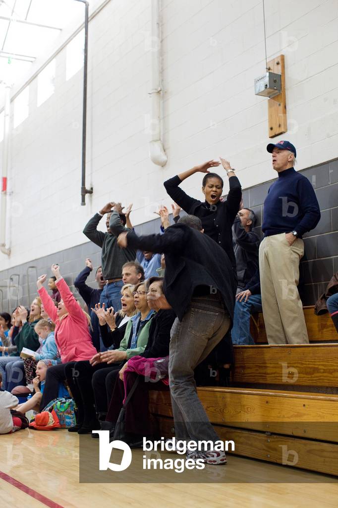 President and Michelle Obama Vice President Joe and Jill Biden react while watching Sasha Obama and Maisy Biden the VP's granddaughter play in a basketball game in Chevy Chase Maryland. Feb. 27 2010.,