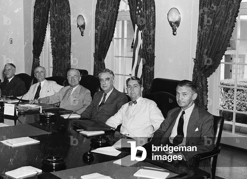 President Harry S. Truman with his cabinet. (from left to right) Postmaster General Robert Hannegan; Secretary of War Henry Stimson; Secretary of State James Byrnes; the President; Secretary of the Treasury Fred Vinson; Attorney General Tom Clark; and Secretary of the Navy James Forrestal. c. 1949