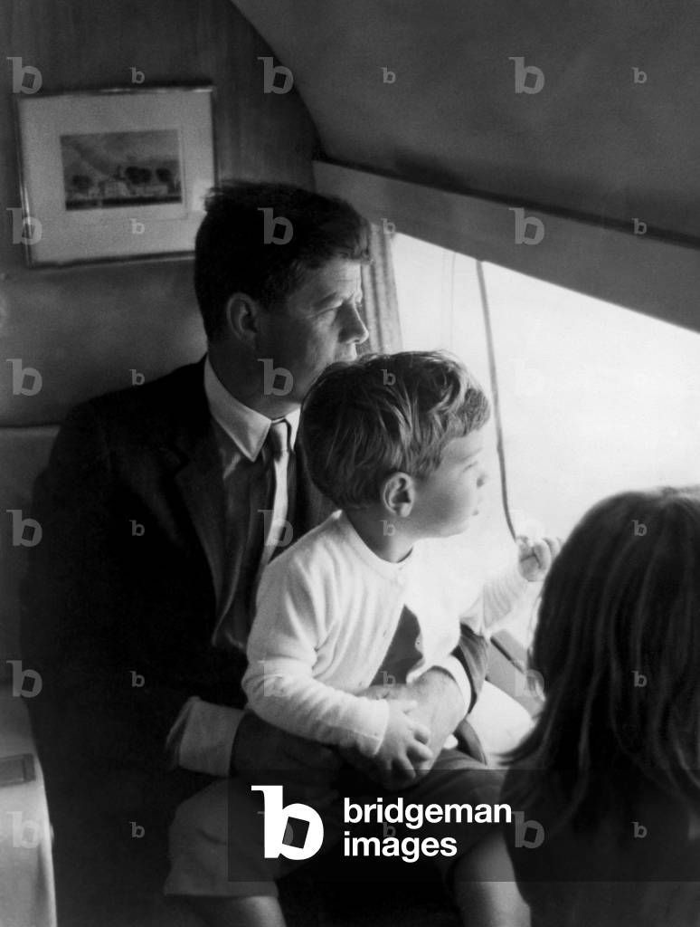 John F. Kennedy, John F. Kennedy Jr. looking out of airplane window (photo)