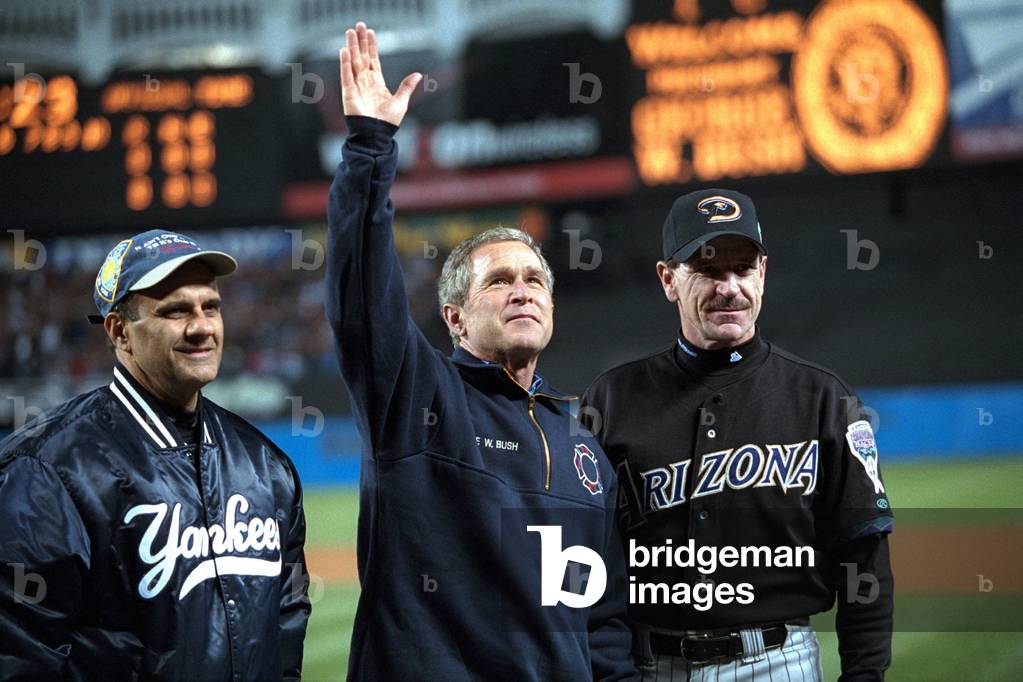 President George W. Bush waves to the World Series crowd at Yankee Stadium. With him are Yankees manager Joe Torre (left) and Diamondbacks manager Bob Brenly. Oct. 30, 2001