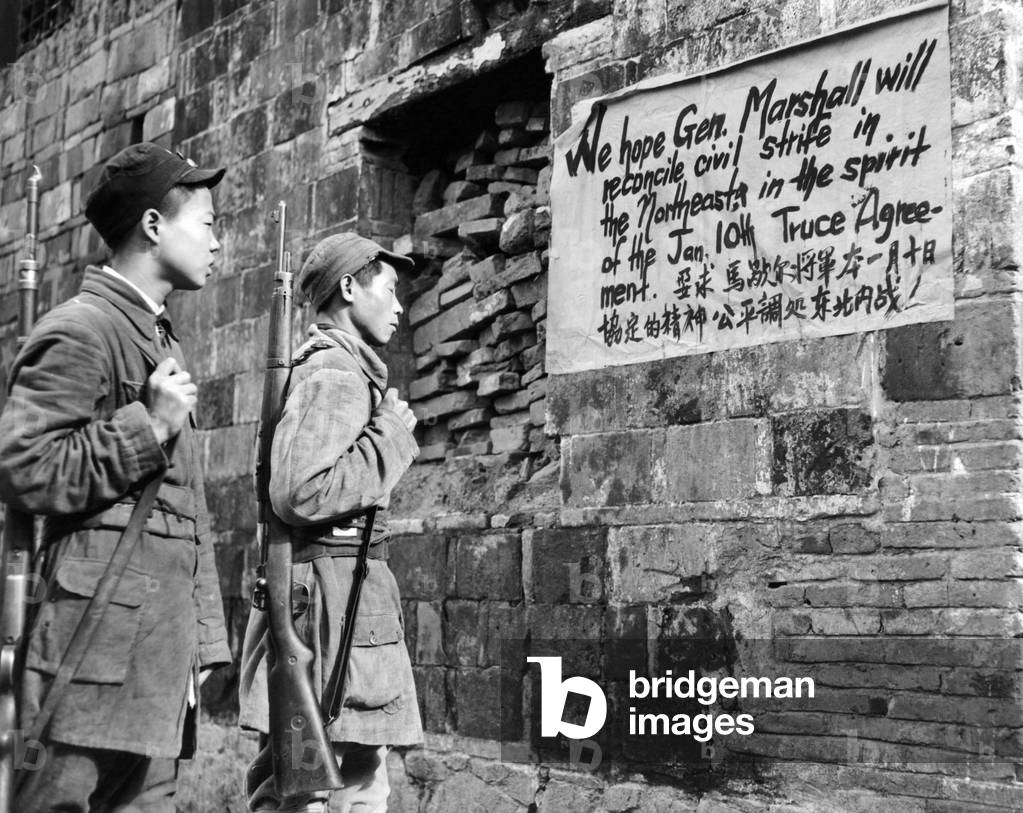 Communist Soldiers of the New Fourth Army reading a sign painted in English and Chinese, urging Sino-American friendship and calling for increased hope that Gen. George C. Marshall (US Secretary of State) will end the civil war in north China. June 7, 1946