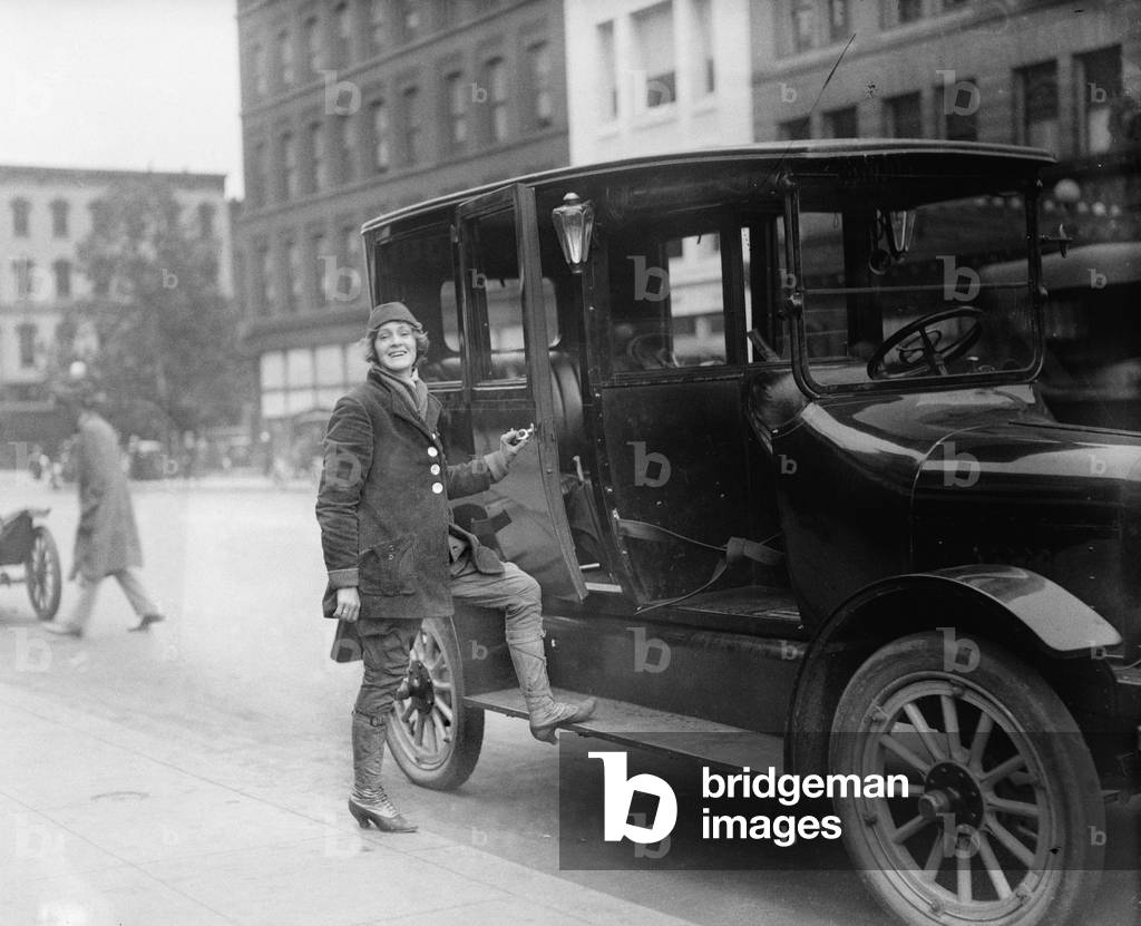 Women taxi driver, dressed in special driving costume, in Washington, D.C. in 1919
